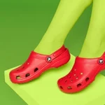 a pair of legs wearing red crocs shoes